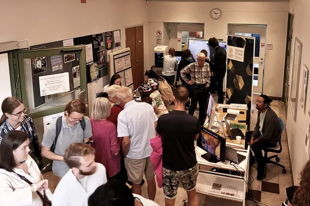 Photo of people mingling in a hallway.